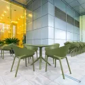 Fauteuil extérieur en polypro vert aménagé sur terrasse intérieure
